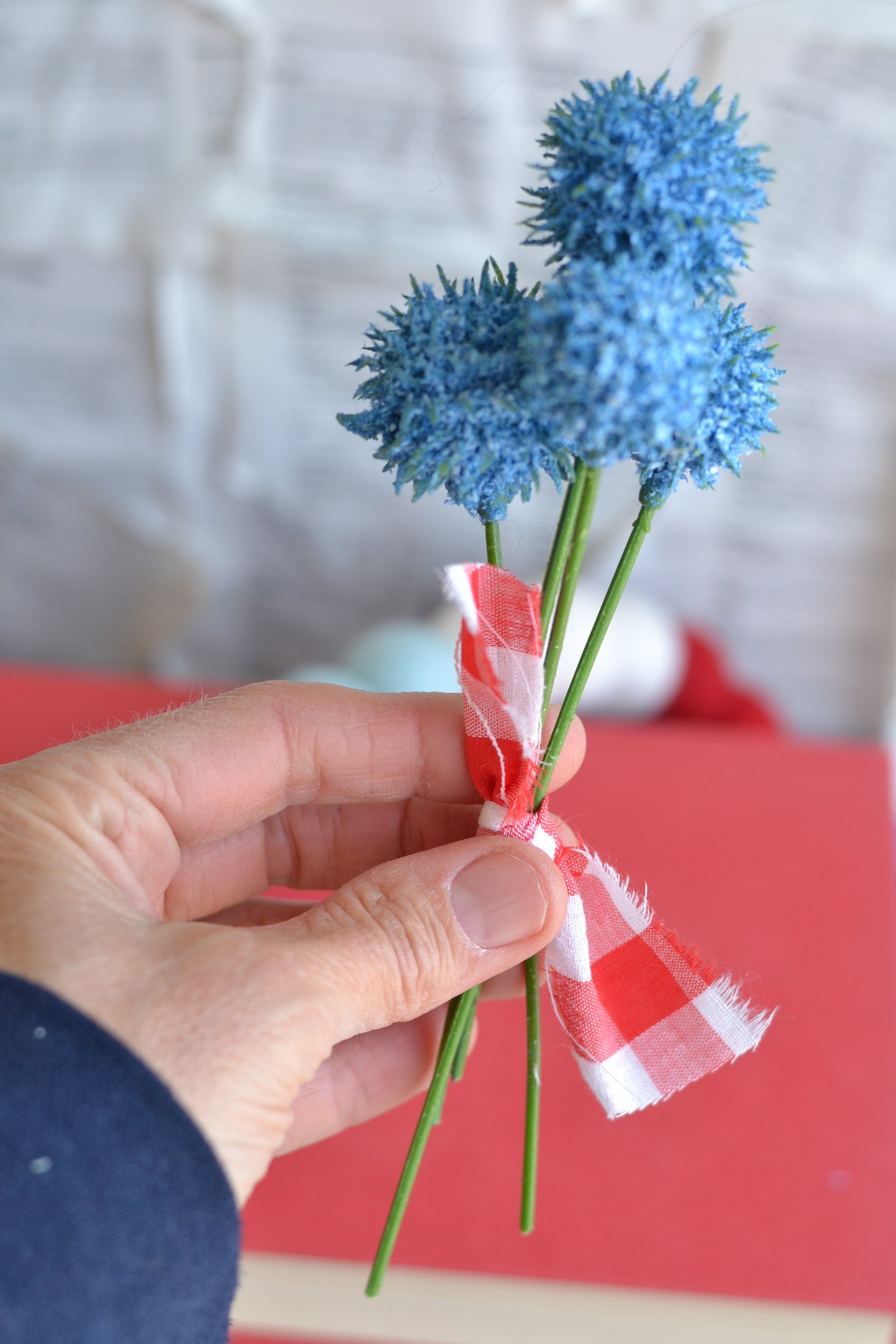 Bundle of blue faux flowers with gingham fabric ribbon tie